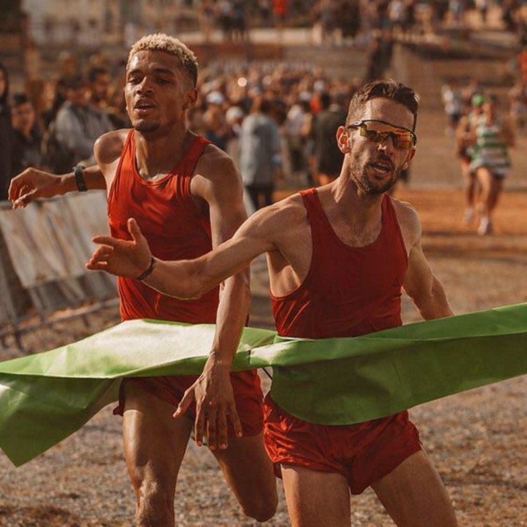 Two determined runners in red tank