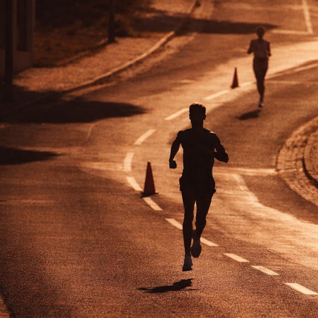 Silhouetted runners glide along
