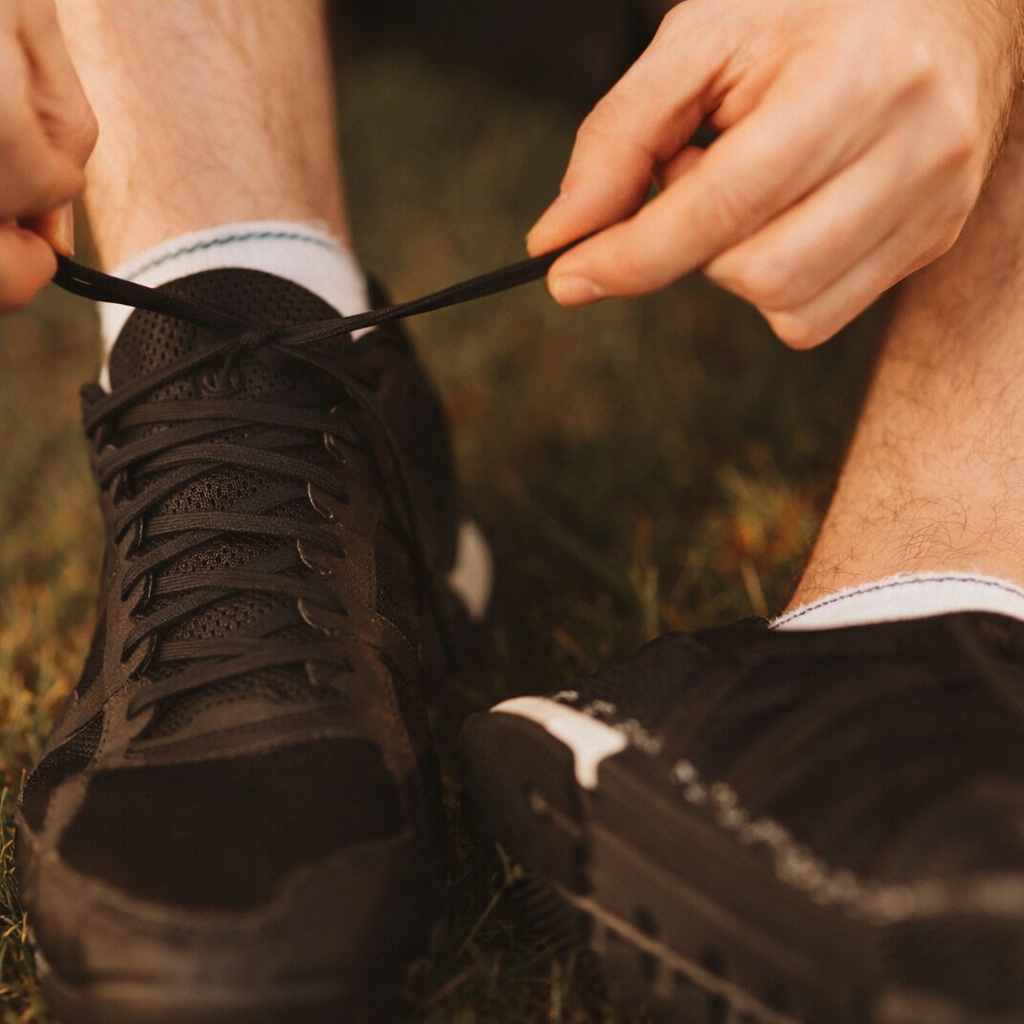 A runner secures their black athletic